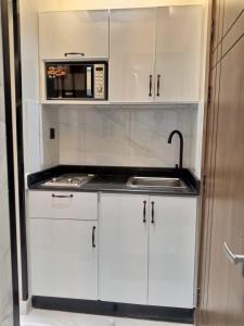 a kitchen with a sink and a microwave at شقق فاخرة in Riyadh