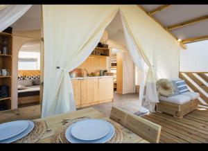 a room with a tent with plates on a table at Agriturismo San Maurizio in Montecatini Val di Cecina