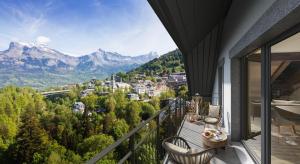 a balcony with a view of a city and mountains at TERRESENS - Les Sources de Canopée in Saint-Gervais-les-Bains