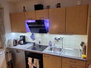 a kitchen with a sink and a stove at Haus Sonnengarten nähe Salzburg mit 2 Bäder in Siegsdorf
