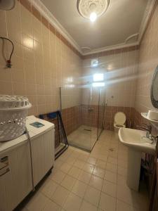 a bathroom with a shower and a toilet and a sink at مساكن المدينة المنورة in Medina