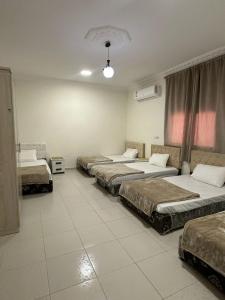 a row of beds in a large room with at مساكن المدينة المنورة in Medina