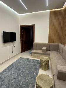 a living room with a couch and a flat screen tv at مساكن المدينة المنورة in Medina