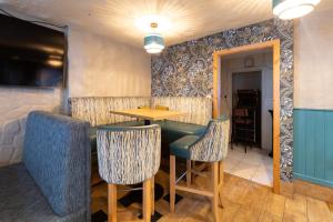 a dining room with a table and chairs at The Derg Arms B&B in Castlederg