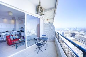 a balcony with a red couch and a table at Villa Paquet - Quartier Art Déco in Casablanca