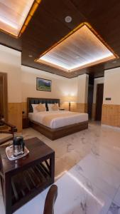 a large bedroom with a bed and a table at दोgri Homes in Kīar
