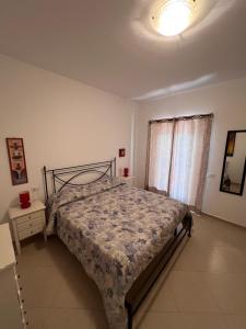 a bedroom with a bed and a light on the ceiling at Villa Althea in Piombino