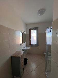 a bathroom with a sink and a toilet at Villa Althea in Piombino +13 photos