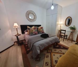 a bedroom with a bed and a mirror on the wall at River Front in Stellenbosch