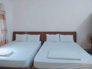 two beds sitting next to each other in a room at Thanh Huyền Motel bãi sau in Vung Tau +1 photo