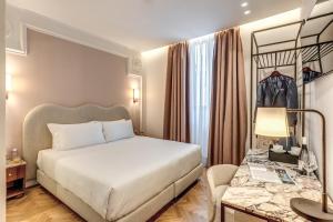 Postel nebo postele na pokoji v ubytování Hotel Fori Imperiali