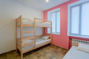 a bunk bed in a room with a window at Comfort Hotel & Hostel in Zaporozhye