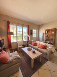 a living room with two couches and a coffee table at COC - Villa Chantoiseau in Wissant