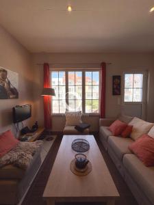 a living room with two couches and a table at COC - Villa Chantoiseau in Wissant