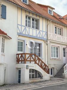 a house with a wooden bridge on the side of it at COC - Villa Chantoiseau in Wissant