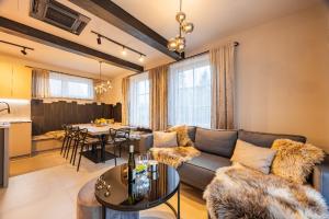 a living room with a couch and a table at Chata Makronka in Orlické Záhoří 