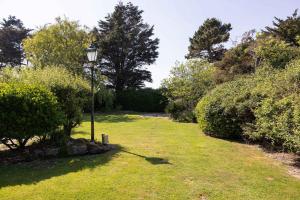 a lamp post in the middle of a lawn at Historic Railway Home - Selsey Seafront in Selsey