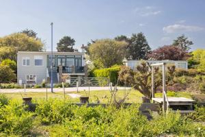 a house with a garden in front of it at Historic Railway Home - Selsey Seafront in Selsey