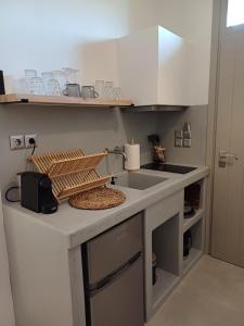 a kitchen with a sink and a counter top at Ραχάτι in Áyios Stéfanos
