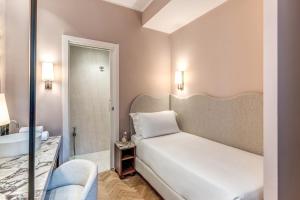 Postel nebo postele na pokoji v ubytování Hotel Fori Imperiali