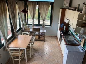 a kitchen with a table and a table and chairs at Appartamento sul Mare in Marina di Massa