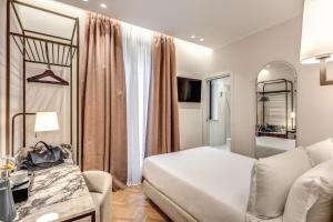 Postel nebo postele na pokoji v ubytování Hotel Fori Imperiali