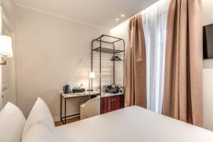 Postel nebo postele na pokoji v ubytování Hotel Fori Imperiali