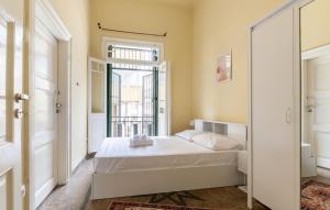 a small bedroom with a bed and a window at The Psyri Collection in Athens