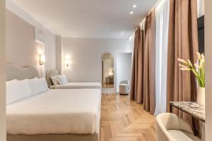 Postel nebo postele na pokoji v ubytování Hotel Fori Imperiali