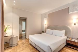 Postel nebo postele na pokoji v ubytování Hotel Fori Imperiali