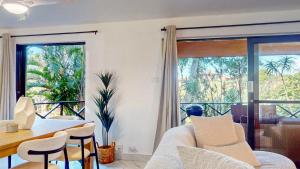 a living room with a couch and a table with chairs at San Lameer Villa 1928 by Top Destinations Rentals in Southbroom
