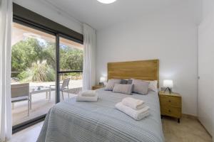 a bedroom with a large bed with white towels on it at AlmeriaSuite Vera Luxury Homes in Vera +66 photos