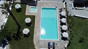 an overhead view of a swimming pool with umbrellas at Fragoulis Village in Parasporos