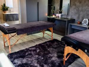 a room with a table and a bench in a room at Pula Nala Lodge Bed & Breakfast in Rustenburg