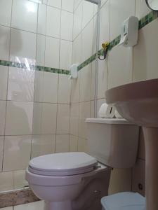 a bathroom with a toilet and a sink at Cantinho da LAGO in Itacuruçá +21 photos