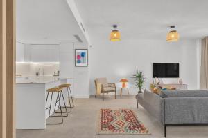 a living room with a couch and a kitchen at Townhouse Eden Golf Chaparral in Málaga