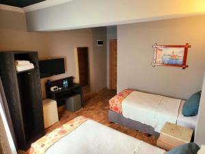 a hotel room with a bed and a tv at City Park Suites City Center Corlu in Çorlu