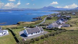 an aerial view of a house on a hill next to the water at Sea for Miles in Renvyle