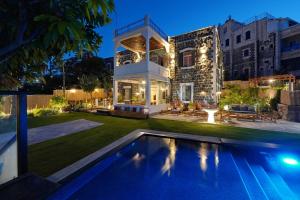 a house with a swimming pool in the yard at Oasis Palace in Tiberias
