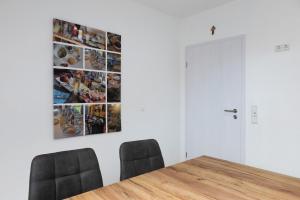 a dining room with a table and two chairs at Ferienwohnung Rhön-Kutscher in Buttlar