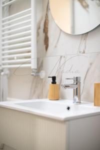 a bathroom with a sink and a mirror at Nadia Apartment in Chioggia