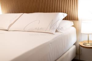 a white bed with white pillows on top of it at Nadia Apartment in Chioggia