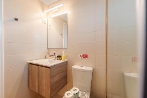 a bathroom with a sink and a toilet and a mirror at Christina's apartment 2 in Kontokali