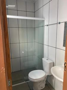 a bathroom with a toilet and a sink at Aconchego in Pelotas