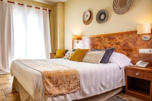 a bedroom with a large bed and a telephone at La Muntanya in Llafranc