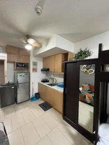 a kitchen with a refrigerator and a counter top at Makati City Antel Spa Residences 1615 in Manila