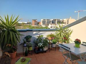 a balcony with a table and potted plants on it at Original - 10 minuti da Matera in Altamura