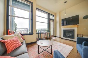 a living room with a couch and a fireplace at 1 Mi to Dtwn Seattle Condo with Garage Parking in Seattle