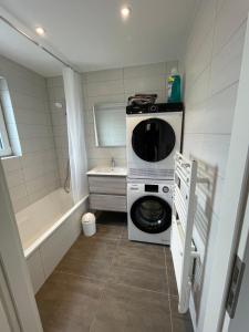 a small bathroom with a washing machine and a tub at Hohwarth - Le Contemporain - Logement 6 personnes in Saint-Pierre-Bois +90 photos