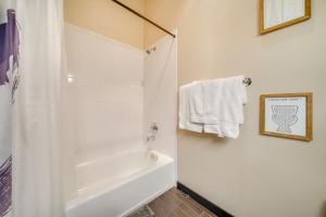 a bathroom with a shower and a white bath tub at 1 Mi to Dtwn Seattle Condo with Garage Parking in Seattle +17 photos